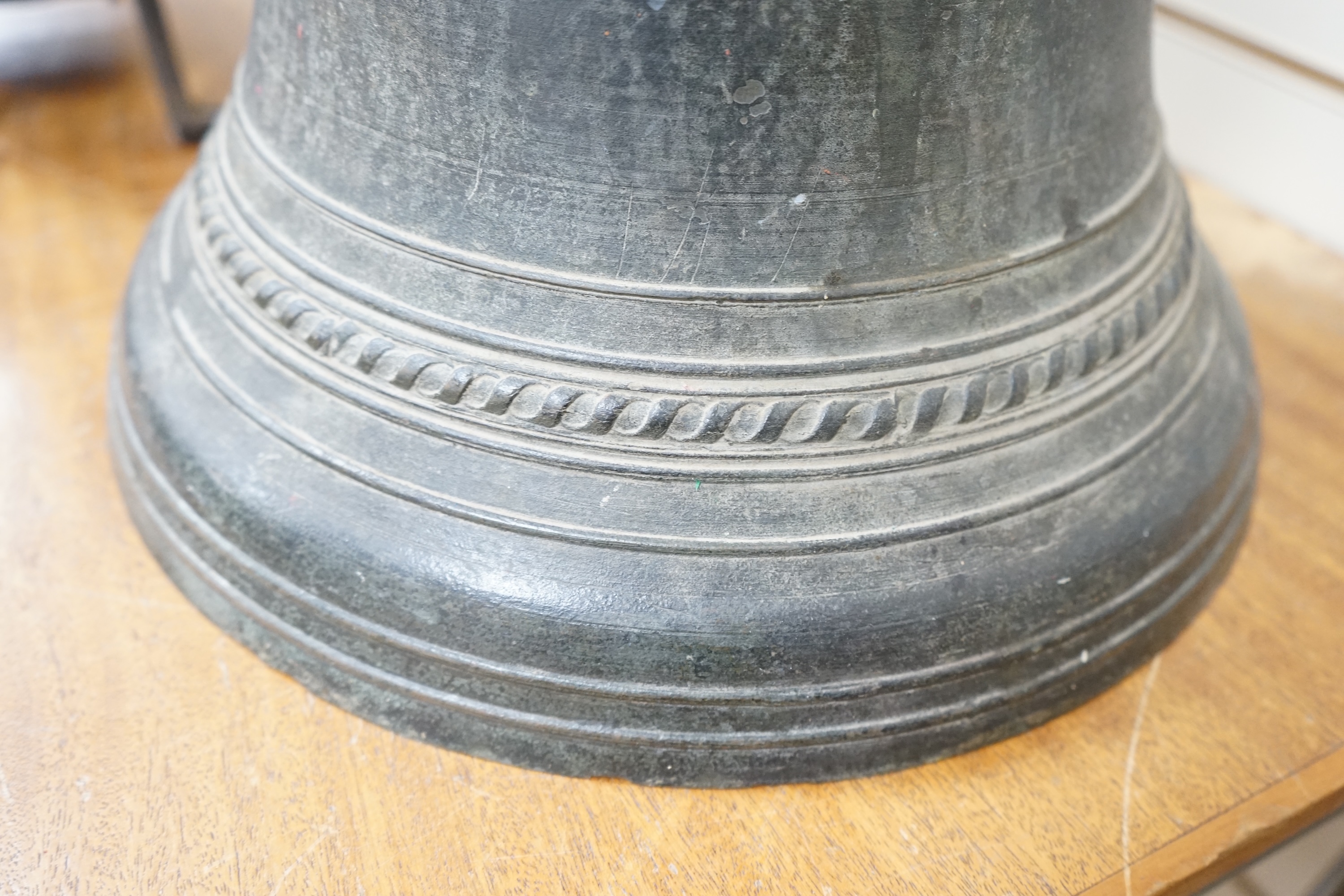 A large Dutch or French cast church bell, 17th/18th century, with decorative Gothic frieze, 33cm high, 40cm diameter. Condition - fair, the crown has been ground off the top.